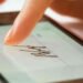 46293960 sign document of deal on digital gadget close up (1)